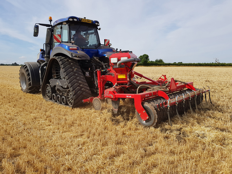HE-VA Multi-Seeder mounted to a HE-VA Subsoiler, behind a New Holland half-trac tractor