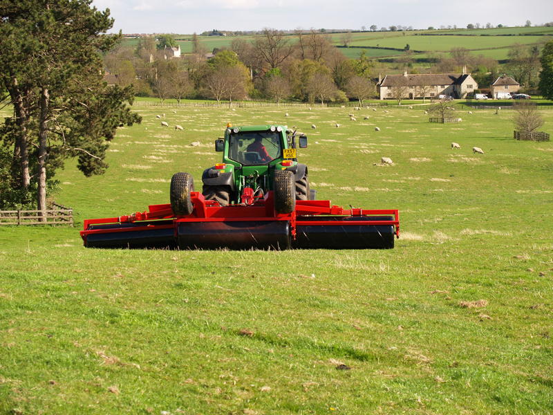 HE-VA Grass Roller behind John Deere tractor pictured in front of farmhouse