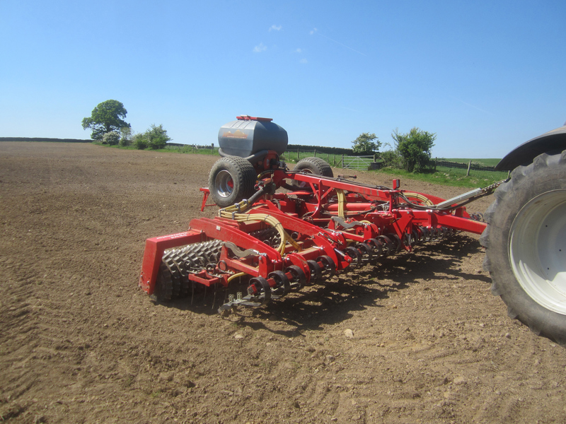 6.3m HE-VA Grass Rejuvenator working into cultivated ground, front view