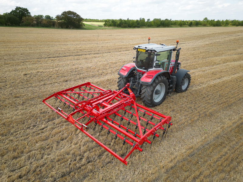 Close-up drone view of 6m HE-VA Top Strigle straw harrow in working position